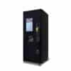 DVS_Joe2Go_-_Wrapped_No_Marquee_-_Web A vending machine that can vend coffee and other hot drinks. It has a touchscreen and is matte black metal
