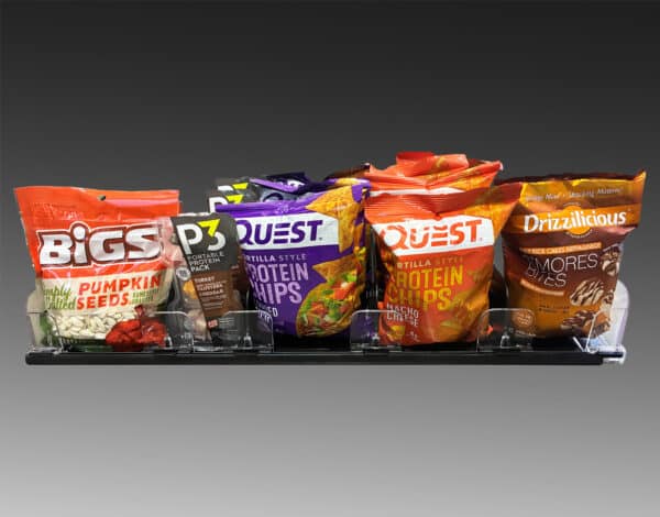 An image showing snack pushers holding large snacks like bags of chips and seeds