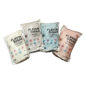 Four bags of sugar for use in a cotton candy machine. The colors are white, red, blue, and orange in order from left to right.